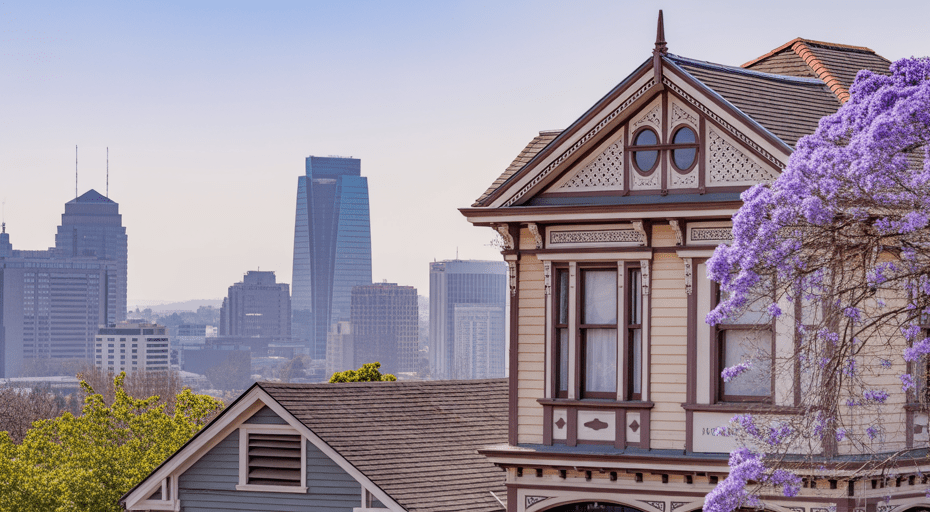 Historic Victorian home with San Jose skyline.